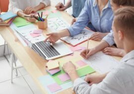 Young team working with marketing plan in office